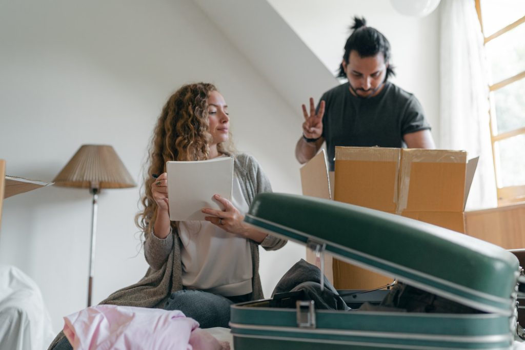 Focused couple packing stuff before moving out